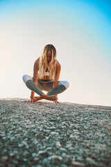 Be a better you, for you. Shot of an athletic young woman practicing yoga on the beach.