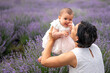 Happy mother with pretty daughter on lavender background.