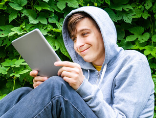 Wall Mural - Young Man with a Tablet Computer