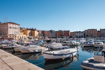 Sticker - Fishing boats anchored in the Rovinj city port, Croatia, during crystal clear winter morning, lit by gentle sun