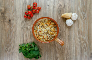 Penne pasta al forno baked in oven with cheese, mushroom and parmegiano top view