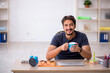 © Elnur - Young male designer working in the office
