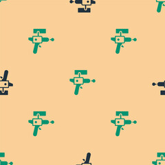 Canvas Print - Green and black Ray gun icon isolated seamless pattern on beige background. Laser weapon. Space blaster. Vector