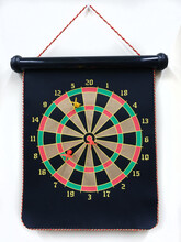 Magnetic Dartboard With Darts Hanging From White Office Wall.