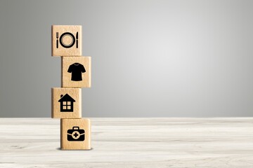 Wall Mural - Wooden cube with food Clothing, housing, medicine, four basic human needs on the desk.