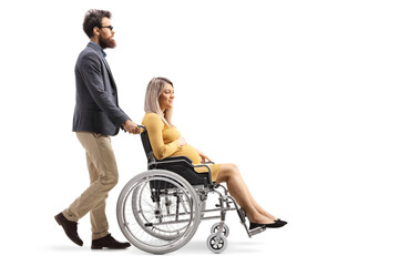 Poster - Full length profile shot of a man pushing a pregnant woman in a wheelchair