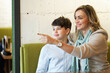 © Teodor Lazarev - A very loving mother hugging her son, the two are sitting in a coffee shop, looking outside the window display