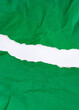 Crumpled green paper torn horizontally with torn edges on a white background. isolated. place for your text.