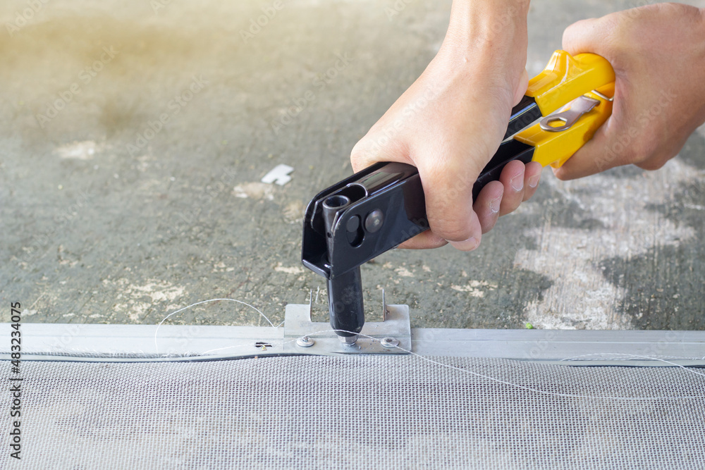 Screen Rivet Mechanic uses pneumatic rivet gun to install a rivet on aluminum sheet ...