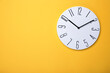© New Africa - Modern clock on yellow background, top view. Space for text