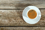 Fototapeta Mapy - Cup of tasty coffee on wooden table, top view. Space for text