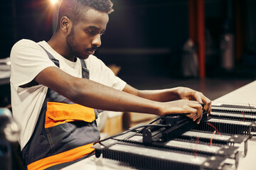 Wall Mural - african man working at led factory