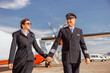 © Kostiantyn - Joyful male pilot and his wife waking hand in hand at airport
