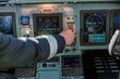 © Kostiantyn - Airline pilot using control panel in aircraft cockpit