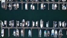Aerial Top-down Eye’s Bird Drone View Over Rows Of Boats Fisherman And Luxury Yacht Moored At Ocean Harbor In Westport Oregon
