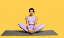 Calm African American Woman Doing Yoga Exercise, Sitting In Baddha Konasana, Bound Angle Or Butterfly Pose