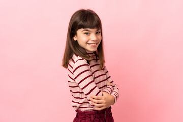 Wall Mural - Little girl isolated on pink background looking to the side and smiling