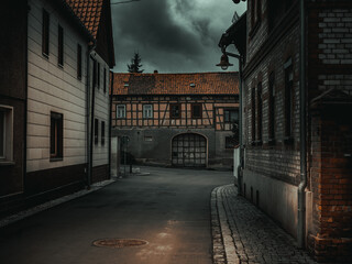 Wall Mural - atmospheric Dark street of an old German city with thunderclouds