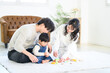 © kapinon - A young family playing with their baby in a beautiful, newly built room with a beautiful mother and her family.
