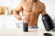 © Prostock-studio - Cropped view of sexy shirtless young man with nakes chest making protein shake at kitchen, closeup