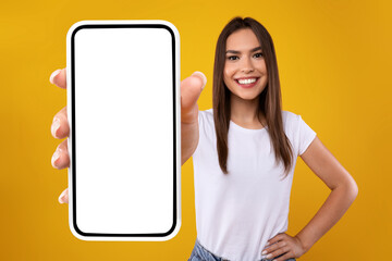 Wall Mural - woman showing white empty smartphone screen close to camera