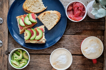 Sticker - Toast with avocado and salmon. Top view, wooden background.