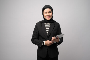 Portrait of young beautiful muslim businesswoman  is holding tablet over white background studio