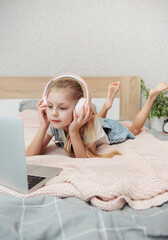 Sticker - Little girl learning online with laptop computer at bedroom.