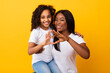 © Prostock-studio - Happy balck mom and girl showing heart symbol with fingers