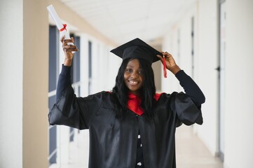 Wall Mural - beautiful young afro american graduate holding diploma