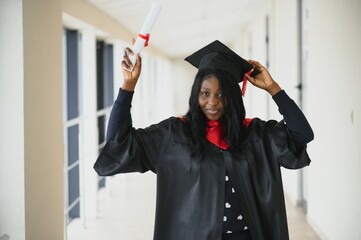 Wall Mural - beautiful african female student with graduation certificate