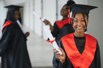 Wall Mural - portrait of multiracial graduates holding diploma