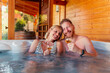 © Impact Photography - Couple making a toast in hot tub