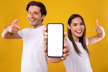 Wall Mural - couple showing blank empty white smartphone screen for mock up