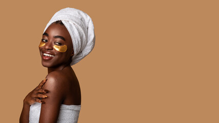 beautiful african american woman wearing golden under eye patches