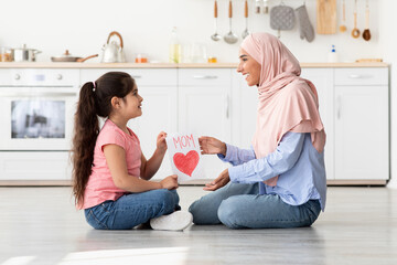 Wall Mural - Happy Mother's Day. Cute Female Child Giving Greeting Card To Islamic Mom