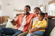 © Rido - Happy african american family watching TV at home