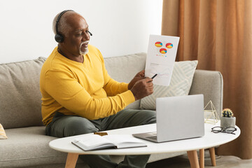 Wall Mural - Senior African Man Video Calling On Laptop Working Online Indoors