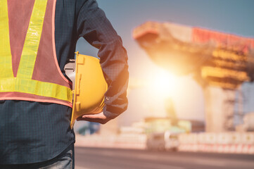 Wall Mural - Engineer construction holding hard hat building structure background