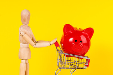 Sticker - a wooden man carries a red pig pig in a trolley from the supermarket on a yellow background