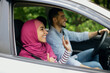 © Prostock-studio - Side View Shot Of Happy Young Muslim Couple Enjoying Car Ride Together