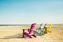 Colorful Lounge Adirondack Chairs At Atlantic Ocean Beach. North Carolina Vacation Scene.