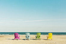 Colorful Lounge Adirondack Chairs At Atlantic Ocean Beach. North Carolina Vacation Scene.
