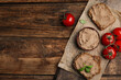 Fresh bread with delicious meat pate, cherry tomatoes and basil on wooden table, flat lay. Space for text