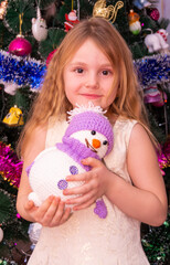 Wall Mural - A beautiful elegant girl near the Christmas tree in the New Year