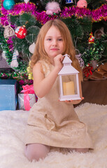 Wall Mural - A beautiful elegant girl near the Christmas tree in the New Year