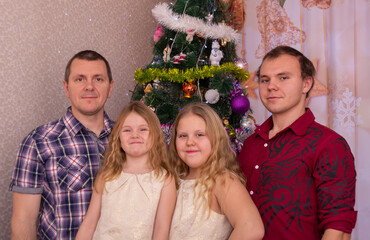 Wall Mural -  Happy family at the Christmas tree on New Year's holidays.