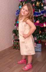 Wall Mural - A beautiful elegant girl near the Christmas tree in the New Year