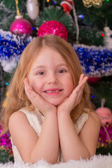 Wall Mural - A beautiful elegant girl near the Christmas tree in the New Year