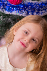 Wall Mural - A beautiful elegant girl near the Christmas tree in the New Year